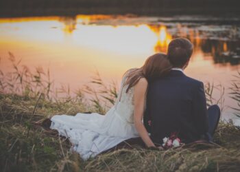 A married couple sit by pond. The image is illustrative. Photo courtesy of Unsplash.