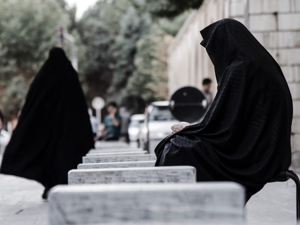 Iranian women must wear traditional Islamic clothing when outside of their homes. Here, two women wearing burkas. Photo by Majid Korang beheshti on Unsplash.