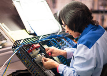 A factory worker in Estonian electronics industry. Photo by Villu Valm