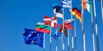 Estonian flag among some of the other EU member states' flags in front of the European Parliament building in Strasbourg, France. Photo by Antoine Schibler on Unsplash.