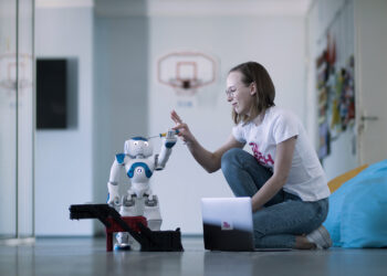 A female student and a robot at TalTech; photo by TalTech.