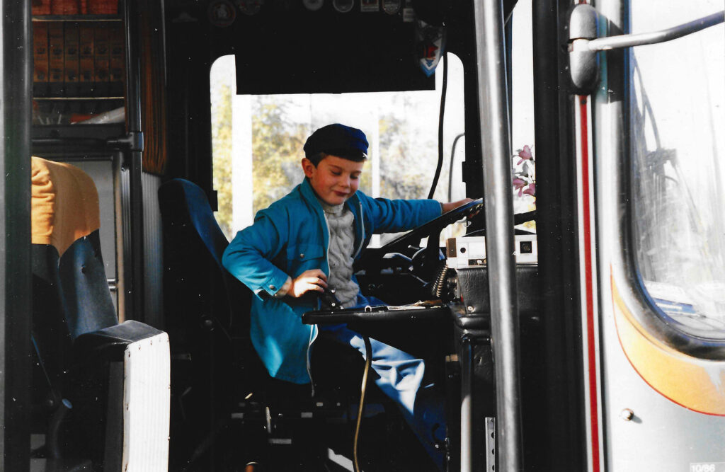 The photo that inspired the cover of "The Grand Illusion" – Sten dry-steering an old bus. He wanted to become a bus driver when he was a kid, and an interest in moving vehicles has accompanied him throughout his life. Photo by Oskar Vihandi.