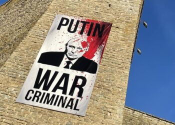 A poster placed on the Narva fortress by the Estonian-Russian border, calling the Russian president Vladimir Putin a war criminal. Photo by Narva Museum.