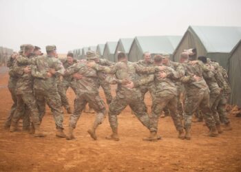 The soldiers of the 145th Field Artillery Regiment, Utah National Guard of the US Army celebrating rain during the African Lion 23 exercise in Morocco in June 2023. Photo by Ariel Solomon, 128th Mobile Public Affairs Detachment.