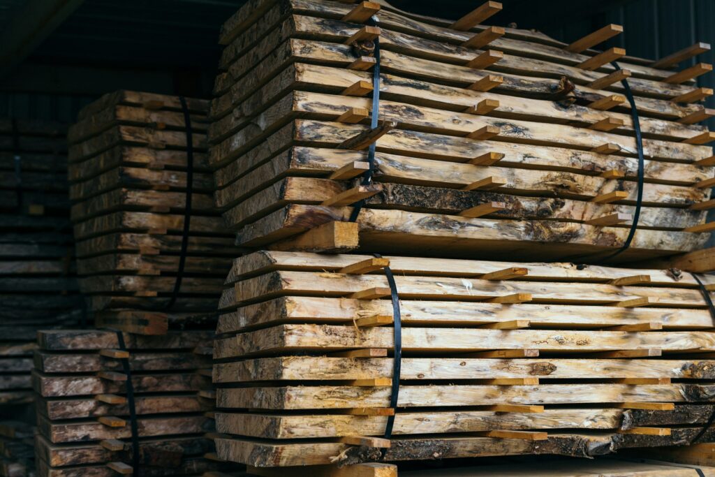 Cut timber at a lumber yard. Photo by Sarah Worth on Unsplash.