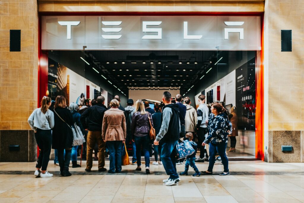 Crowd outside a Tesla store in the UK. Photo by Chris Boland/Unsplash.