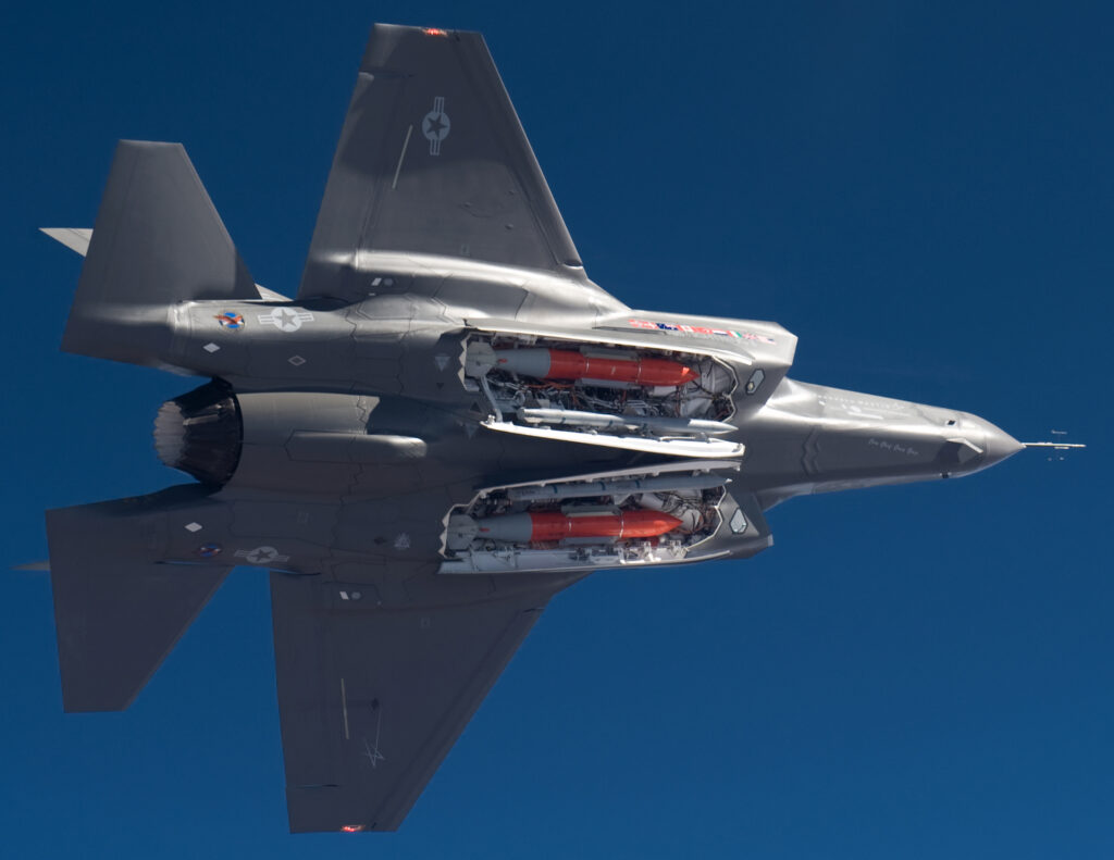 A US Air Force F-35A with open weapon bays carrying two B61 nuclear bombs and two AIM-120 AMRAAM missiles. Public domain.