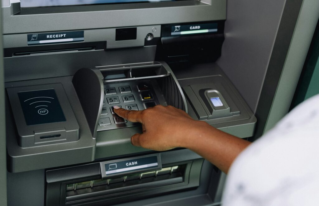 The Estonian central bank is predicting that wages will grow by over 8% in 2026. Pictured, a person withdrawing money from an ATM. Photo by Ali Mkumbwa on Unsplash.