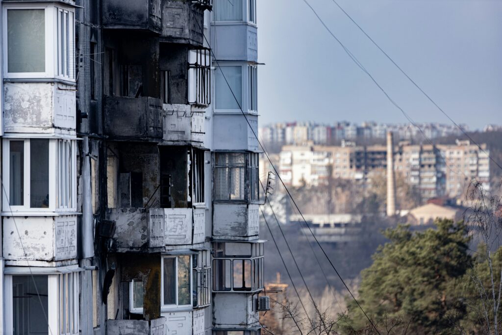 A damaged residential building following a Russian missile strike in Irpin, Kyiv Oblast, Ukraine. Photo by Andrew Petrischev/Unsplash.