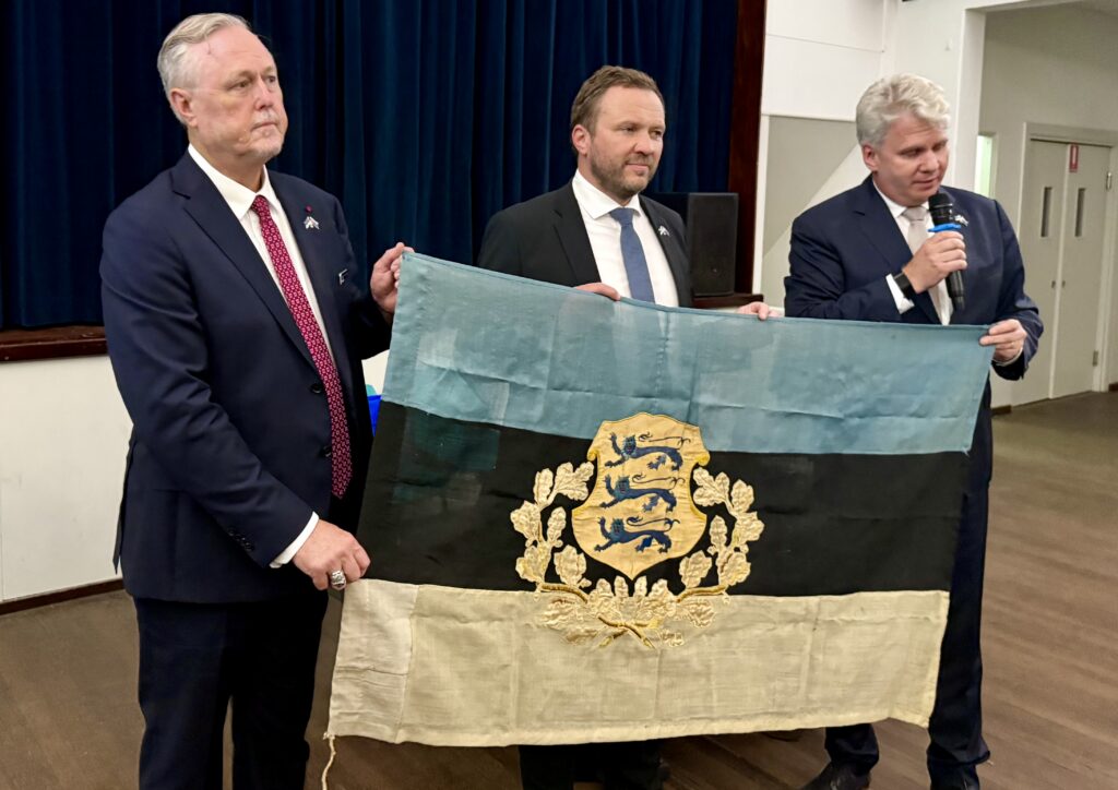 A historic Estonian flag, rescued from Kadriorg Palace in September 1944 as Soviet forces closed in on Tallinn, is displayed at the Estonian House in Sydney, from where the Estonian foreign minister Margus Tsahkna, centre, will bring it back to Estonia. Photo: the Estonian foreign ministry.