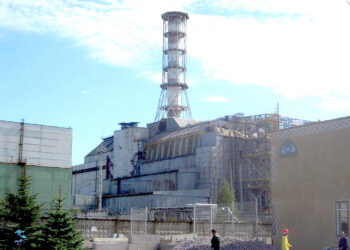 The Chernobyl reactor No 4 building in 2006, including the later-built sarcophagus and elements of the high-security perimeter. Photo: Carl Montgomery / CC BY 2.0 licence.