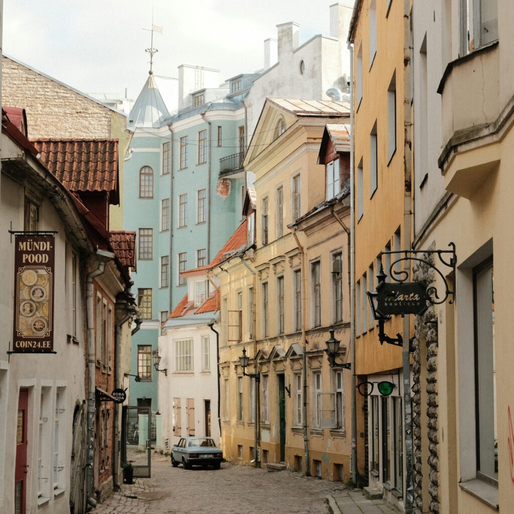 A quiet cobbled street in Tallinn’s Old Town, where empty premises and fading shopfronts tell their own story. Photo by Austin Curtis on Unsplash.