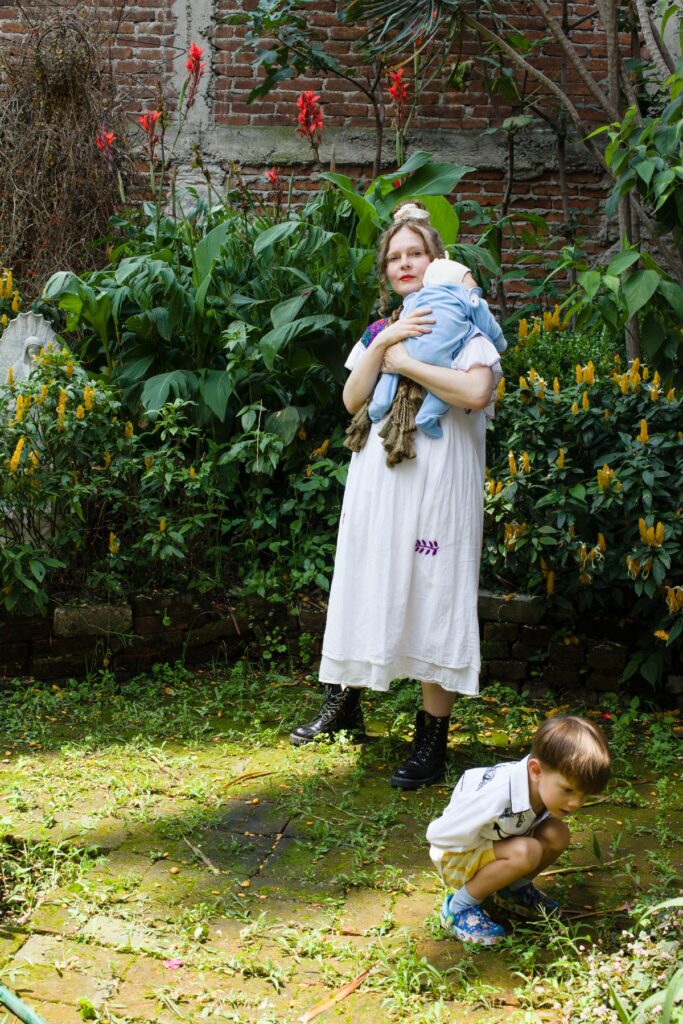 Merike Estna with her children in her studio garden in Mexico City in 2025. Photo by Aime Estna.
