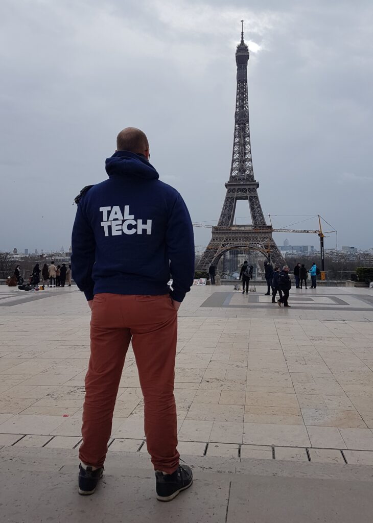 Brendan Pasco Rajalo wearing a TalTech hoodie in Paris, with the Eiffel Tower in the background. His Estonian roots and French upbringing have shaped a career that now connects both countries. Private collection.
