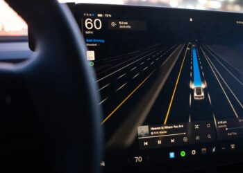 A Tesla’s driver assistance display showing the car monitoring surrounding lanes while in self-driving mode. Photo by Josh Sorenson on Unsplash.