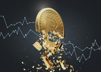 A broken Bitcoin token against a falling market chart. Photo by Getty Images/Unsplash.