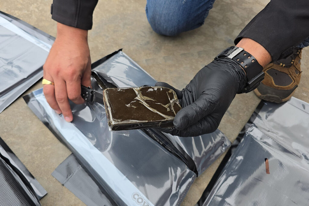 Paraguayan anti-drug agents inspect a package of suspected hashish found on the private jet. Photo by SENAD.