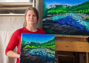 Keili Major in her Garessio studio with two finger-painted landscapes of the Tanaro river. Private collection.