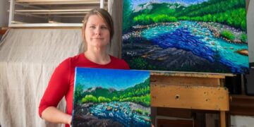 Keili Major in her Garessio studio with two finger-painted landscapes of the Tanaro river. Private collection.