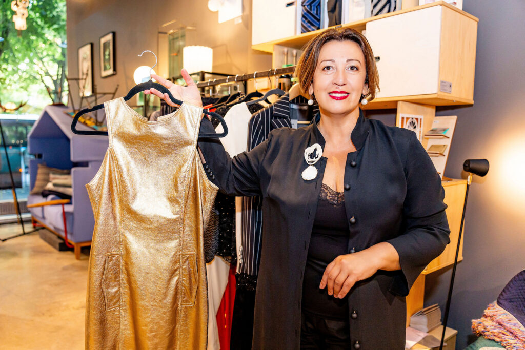 Oksana Tandit with one of her creations. Quality fabrics, expert tailoring and longevity remain central to her work. Photo: Liis Mutli Photography.