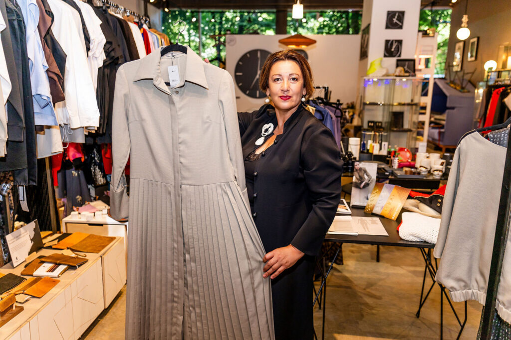 Oksana Tandit with a pleated dress from her collection. In recent years, she has concentrated chiefly on bespoke commissions. Photo: Liis Mutli Photography.