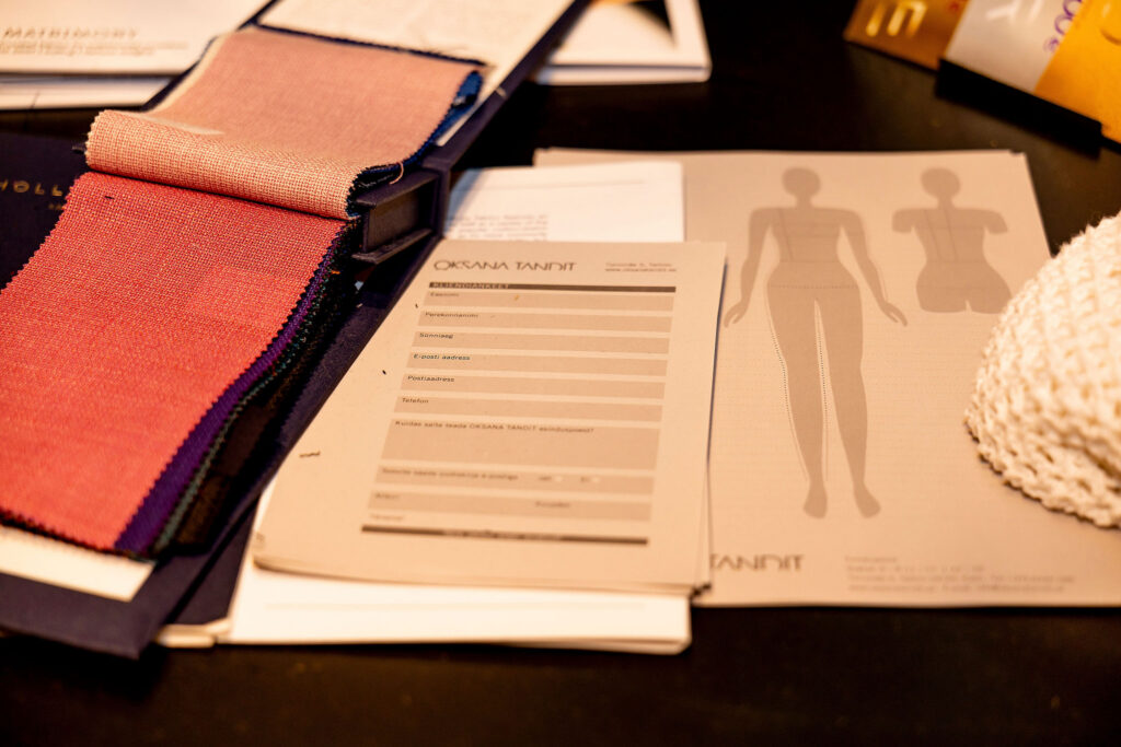 Fabric swatches, figure sketches and client forms offer a glimpse of the bespoke design process behind Oksana Tandit’s work. Photo: Liis Mutli Photography.