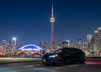 An AI rendering of the Ford Mustang Mach-E and Downtown Toronto with its famous landmark, the CN Tower. Photo: Gemini AI.