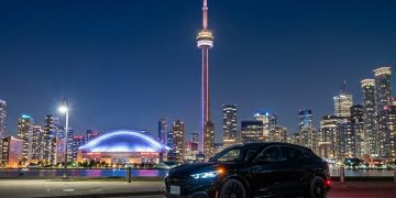 An AI rendering of the Ford Mustang Mach-E and Downtown Toronto with its famous landmark, the CN Tower. Photo: Gemini AI.